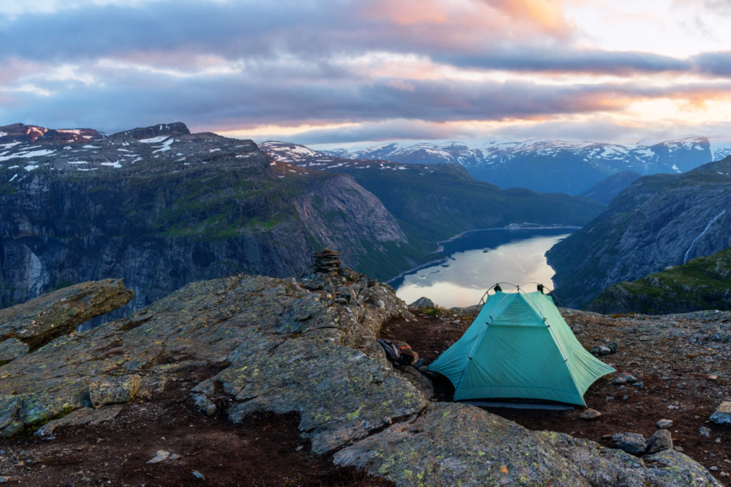 Alone tent near Trolltunga rock - most spectacular and famous scenic cliff in Norway