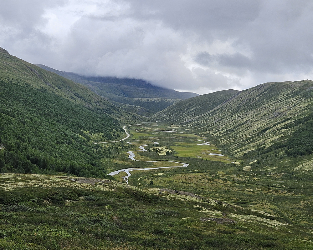Tour de Dovre og utsikt over dalføre i fjellet.