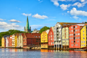 Old wooden houses and Nidaros cathedral over Nidelva river in Trondheim, Norway